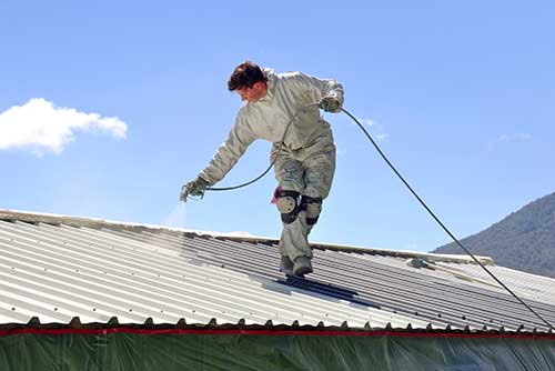 painting a commercial roof outdoors